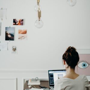 a woman sitting in front of a laptop