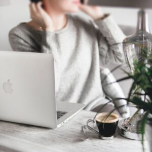 a woman sitting behind a laptop