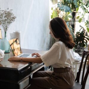 a woman typing on a laptop